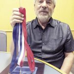 David Lapakko holds medals from Great American Think Off